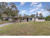 Ranch style home with carport, mature landscaping, and spacious yard at 3107 S Park Ave, Sanford, FL 32773