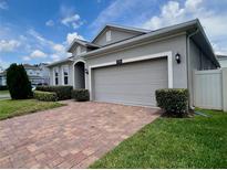 Well maintained home with a brick paver driveway, mature landscaping and a two car garage at 3333 Wauseon Dr, St Cloud, FL 34772