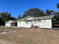 Ranch-style home with light green exterior and mature landscaping at 3457 Seminole St, Gotha, FL 34734