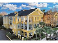 Attractive yellow 3-story building with balconies and landscaping at 3593 Conroy Rd # 413, Orlando, FL 32839