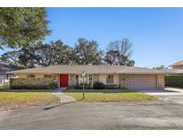 House exterior featuring a red door and stone facade at 754 E Wildmere Ave, Longwood, FL 32750