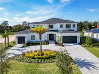 Two-story home with gray roof and landscaping at Lot 5 Yellowleaf Circle, Orlando, FL 32820