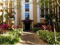 Attractive building exterior with landscaping and walkway at 12527 Floridays Resort Dr # 611-E, Orlando, FL 32821