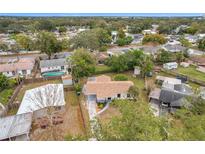 Aerial view of a single-Gathering home with a well-maintained lawn and mature trees in a quiet neighborhood at 1630 Smithfield E Cir, Lakeland, FL 33801