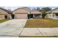 Two-story house with attached garage and landscaping at 2058 Newtown Rd, Groveland, FL 34736