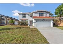 Two-story house with a red tile roof, attached garage, and a spacious front yard at 2988 Stillwater Dr, Kissimmee, FL 34743