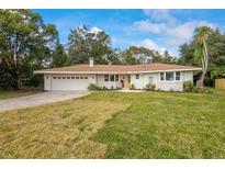 Charming ranch home with updated brick exterior, new landscaping, and a spacious yard at 332 Lake Winnemissett Dr, Deland, FL 32724