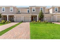 Townhouses with 2-car garages and landscaped yards at 3564 Landing Net Dr, Kissimmee, FL 34746