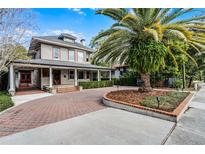 Large two-story house with a wrap-around porch and brick driveway at 567 Osceola Ave, Winter Park, FL 32789