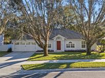 House exterior featuring a two-car garage and manicured lawn at 856 La Gran Via Lane, Apopka, FL 32703