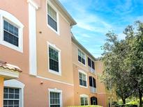 A view of the exterior of the building, with multi-level units and manicured landscaping at 13536 Turtle Marsh Loop # 538, Orlando, FL 32837