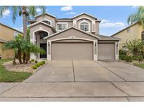 Two-story house with a large driveway and landscaped front yard at 14742 Masthead Landing Cir, Winter Garden, FL 34787