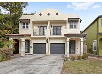 Two-story duplex with Spanish-style architecture, featuring two attached garages at 2607 E Jefferson St, Orlando, FL 32803