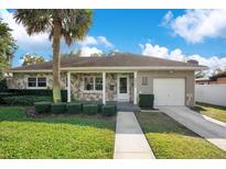 Charming ranch home with stone exterior, spacious yard, and a two-car driveway at 2842 Eastern Pkwy, Winter Park, FL 32789