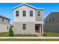 Two-story house with gray siding, red door, and small front yard at 360 Belmond Dr, Debary, FL 32713