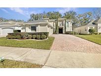 Two-story house with brick paver driveway and manicured landscaping at 4957 Rock Rose Loop, Sanford, FL 32771