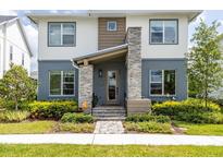 Two-story home with stone accents and landscaped front yard at 6921 Arnoldson St, Orlando, FL 32827