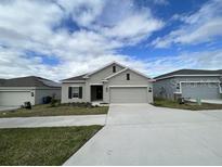 New single-story home with attached garage and neutral exterior at 807 Ofanto Way, Haines City, FL 33844