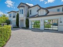 Two-story house with stone accents and a three-car garage at 900 Jack Nicklaus Ct, Kissimmee, FL 34747