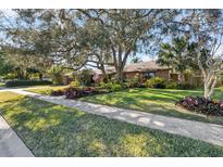 Charming home with lush landscaping and mature trees at 230 W Spring Lake Dr, Altamonte Springs, FL 32714