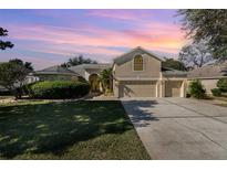 Beautiful two-story home with a three-car garage and manicured lawn at 3518 Kilmarnock Dr, Apopka, FL 32712
