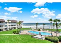 Resort-style pool and patio area with stunning ocean views at 3663 S Atlantic Ave # 11D, New Smyrna Beach, FL 32169