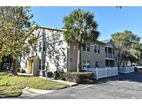 Building exterior with landscaping and white picket fence at 2519 Kilgore St # 203, Orlando, FL 32803