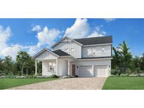 Two-story modern farmhouse with white siding, gray roof and a two-car garage at 1467 Ridgeback Ln, Apopka, FL 32703