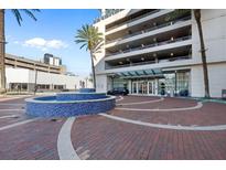 Elegant building entrance with fountain and brick pavers at 150 E Robinson St # 14A, Orlando, FL 32801