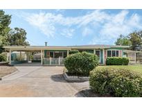 Charming single-story home with a covered carport, mature landscaping, and a quaint front porch at 213 Oakland Ave, Sanford, FL 32773