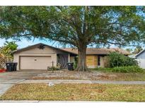 One-story house with fire damage, boarded windows, and overgrown landscaping at 2667 Fitzhugh Rd, Winter Park, FL 32792