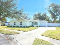 Light teal single story home with well manicured lawn and driveway at 30 Old Barn Way, Casselberry, FL 32707