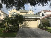 Two-story house with a large three-car garage and manicured landscaping at 9132 Via Bella Notte, Orlando, FL 32836