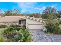 Ranch style home with stone accents, attached garage, and landscaped yard at 106 Canterbury Dr, Haines City, FL 33844