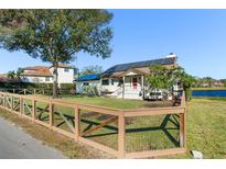 Charming house exterior with solar panels and a wooden fence at 1141 Edgewood Ranch Rd, Orlando, FL 32835