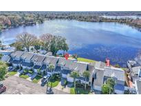 Aerial view of townhouses near lake, showcasing waterfront location and community at 174 Northshore Cir, Casselberry, FL 32707