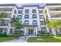 Three-story building exterior with palm trees and manicured landscaping at 4012 Breakview Dr # 405, Orlando, FL 32819