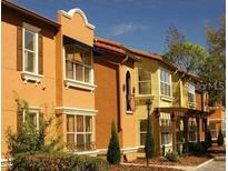 Attractive row of townhouses with Spanish-style architecture at 5112 Conroy Rd # 13, Orlando, FL 32811