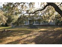 Ranch style home with tree lined yard and walkway at 560 Eden Dr, St Cloud, FL 34771