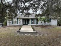 Single-story house with double doors, green shutters, and a stone walkway at 560 Eden Dr, St Cloud, FL 34771