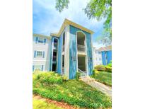 Charming condo building with blue and white accents and well-maintained landscaping at 8203 Olympia Ct # 8203, Longwood, FL 32779