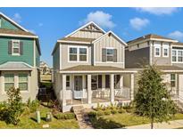 Two-story craftsman style home with front porch and landscaping at 15450 Lebeau Loop, Winter Garden, FL 34787