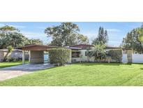 Mid-century ranch home with carport and well-manicured lawn at 2100 Suffield Dr, Winter Park, FL 32792