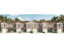 Modern townhome community with attached garages and neutral color palettes at 2909 Hudson Hammock Way, Saint Cloud, FL 34773