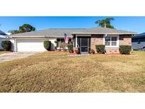 Brick home with a screened porch and nicely landscaped yard at 425 Iowa Woods E Cir, Orlando, FL 32824