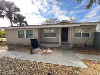 Tan single-story house with a black door and small front yard at 4405 Barley St, Orlando, FL 32811