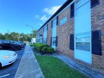 Brick building exterior with parking and landscaping at 5325 Curry Ford Rd # 101, Orlando, FL 32812