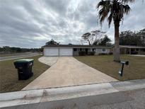 Ranch style home with two-car garage and driveway at 5822 Forest Grove Blvd, Orlando, FL 32808