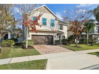 Two-story house with brown brick driveway and landscaping at 611 Marsh Reed Dr, Winter Garden, FL 34787