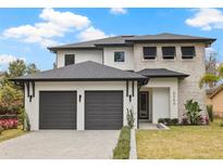 Stunning two-story home boasting a modern design, two-car garage, and well-manicured landscaping at 6564 Lagoon St, Windermere, FL 34786